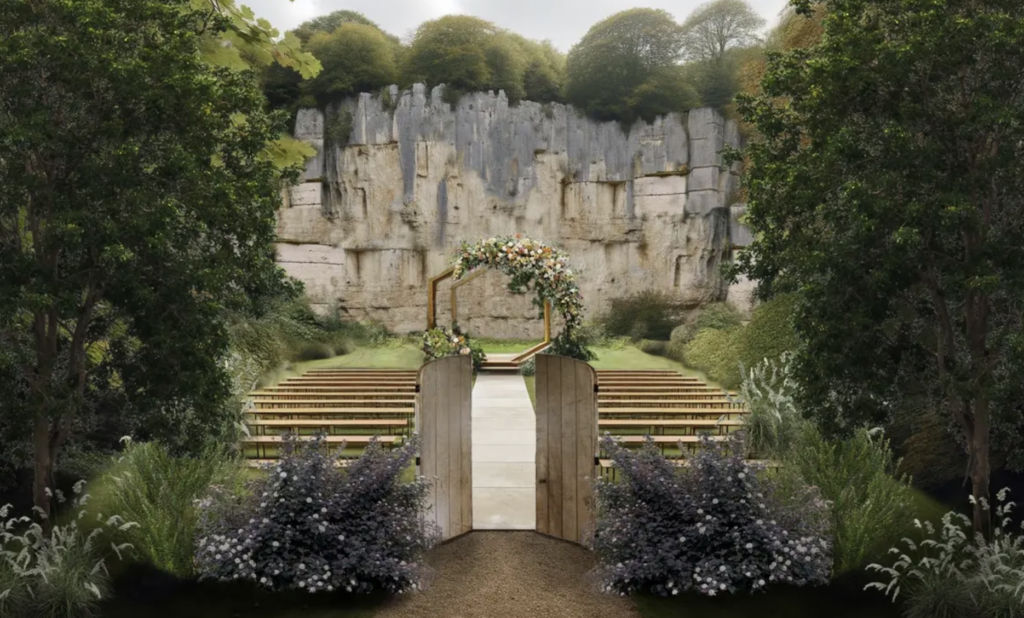 The outdoor wedding ceremony site for Woods & Co with wooden doors and facing a rock cliff.